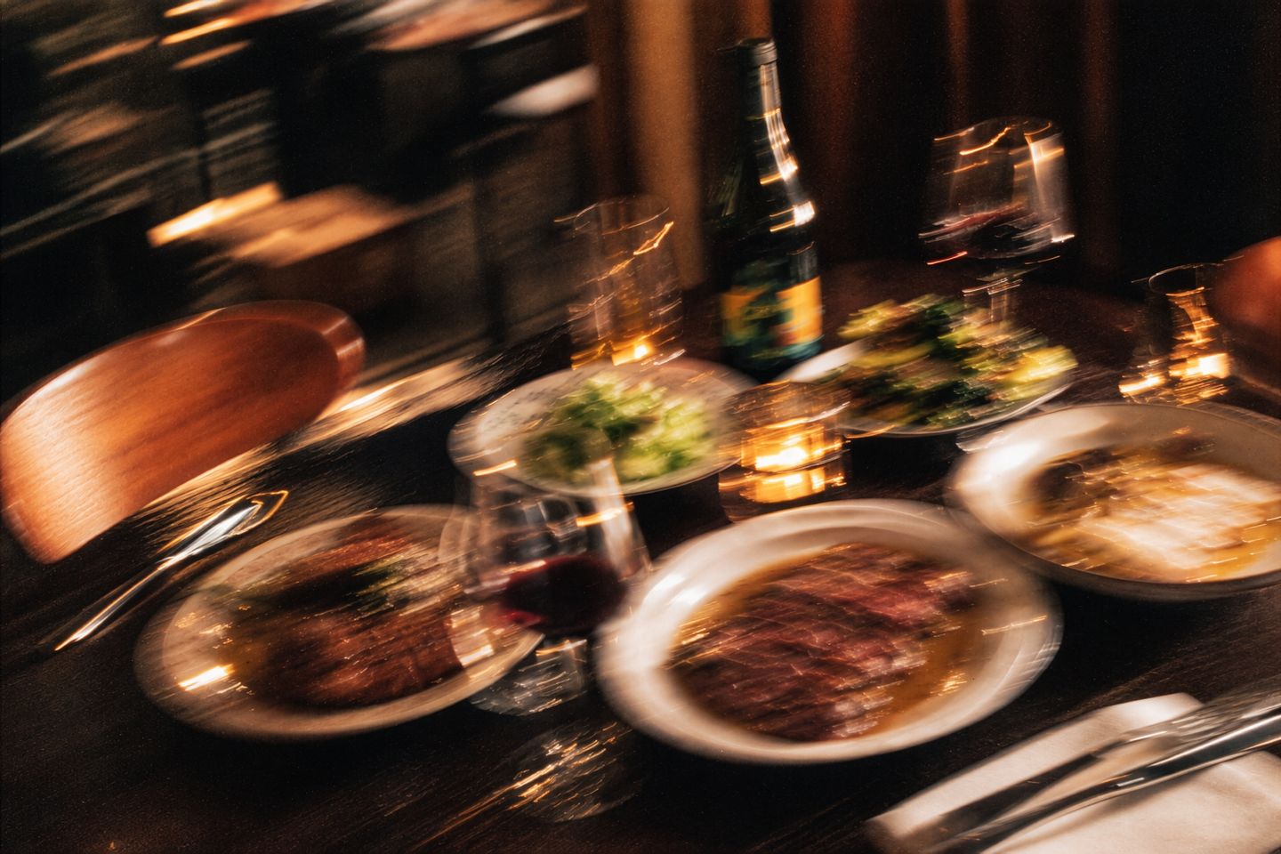 Candlelit table of shared plates, wine and a bottle in the dining room at Sonny's, Mount Hawthorn.